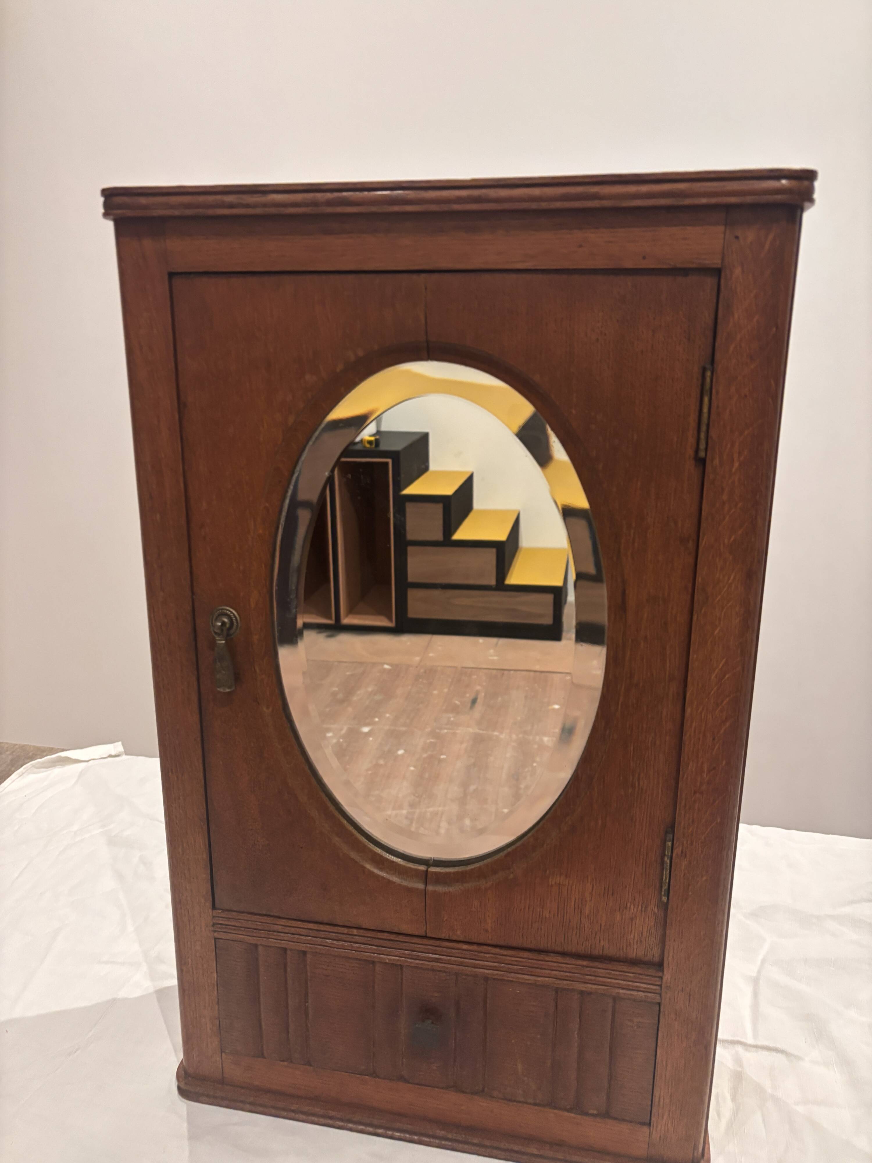 Wall cabinet with oval wall and drawer