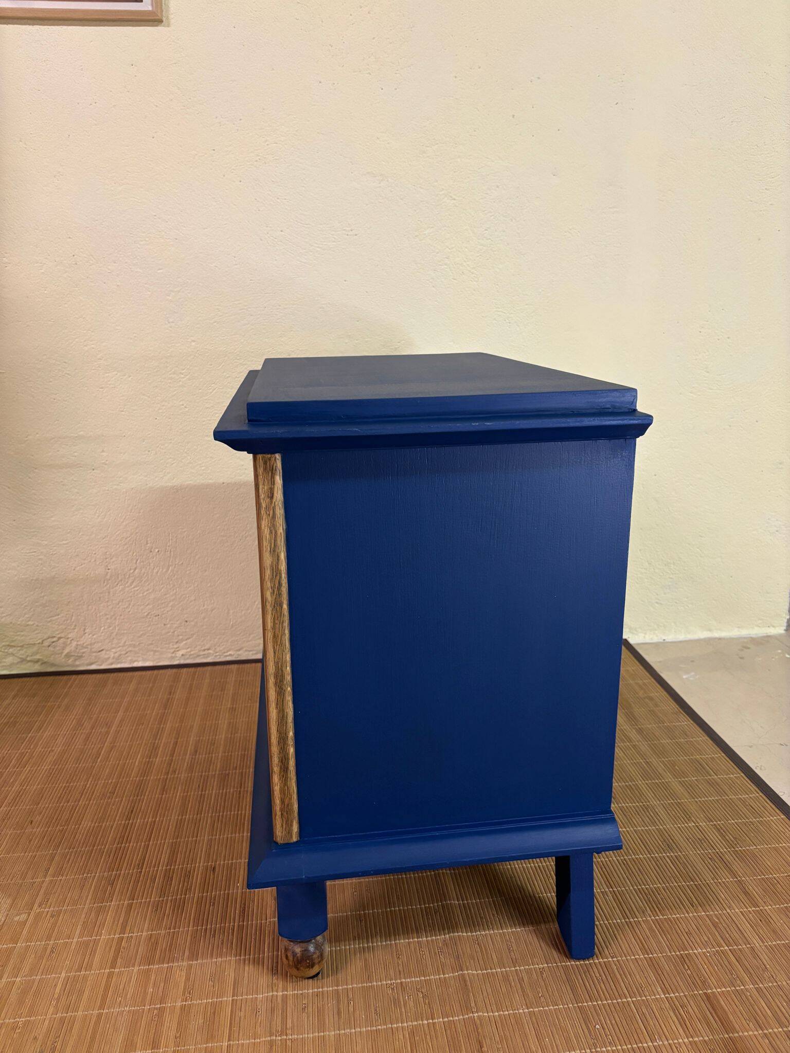 Small vintage upcycled side table in midnight blue and raw wood, with a rose-shaped door.