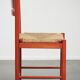 Red vintage wooden chair from the 1970s with a woven wicker seat