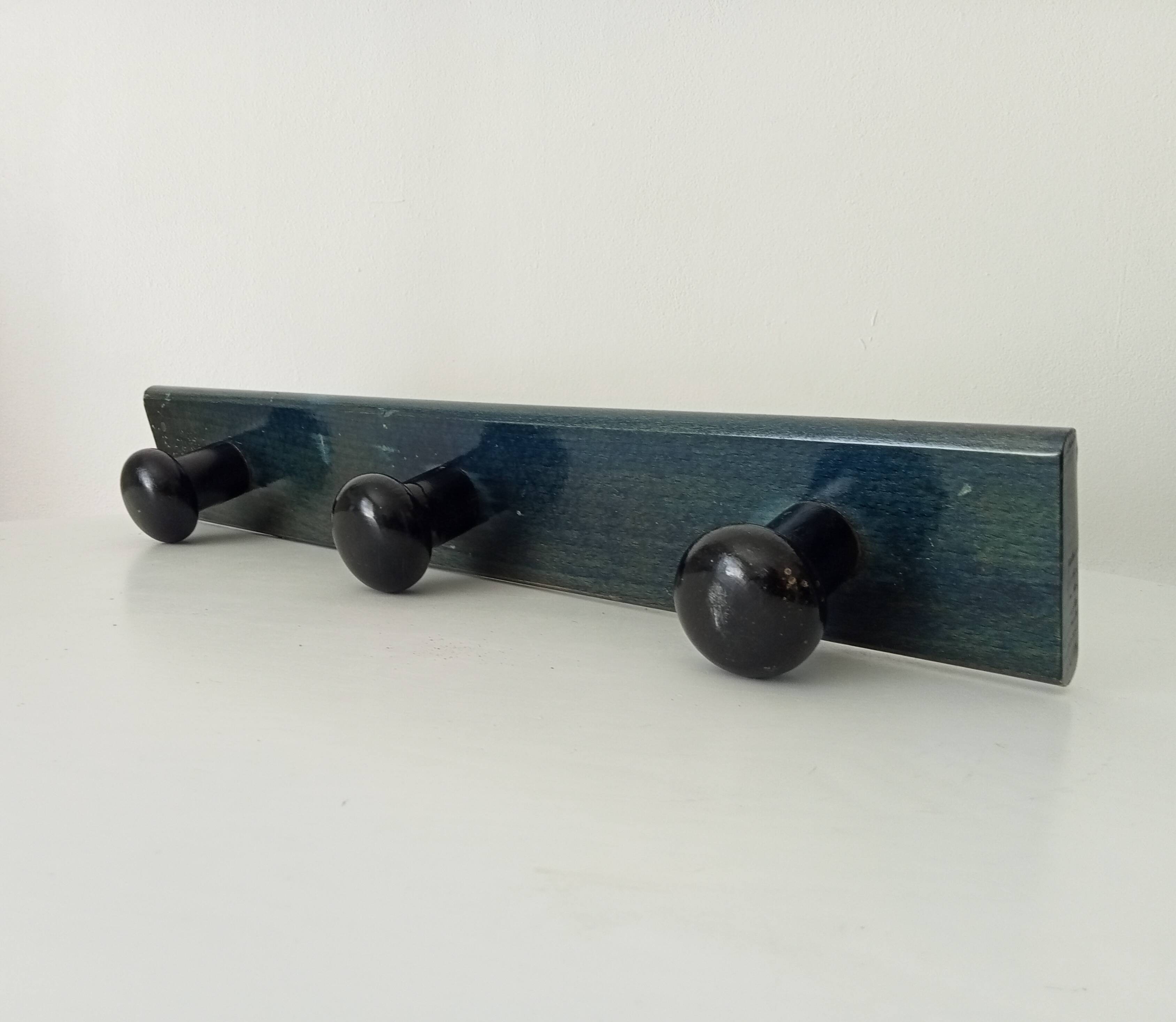Vintage wall-mounted coat rack in lacquered wood from the 60s