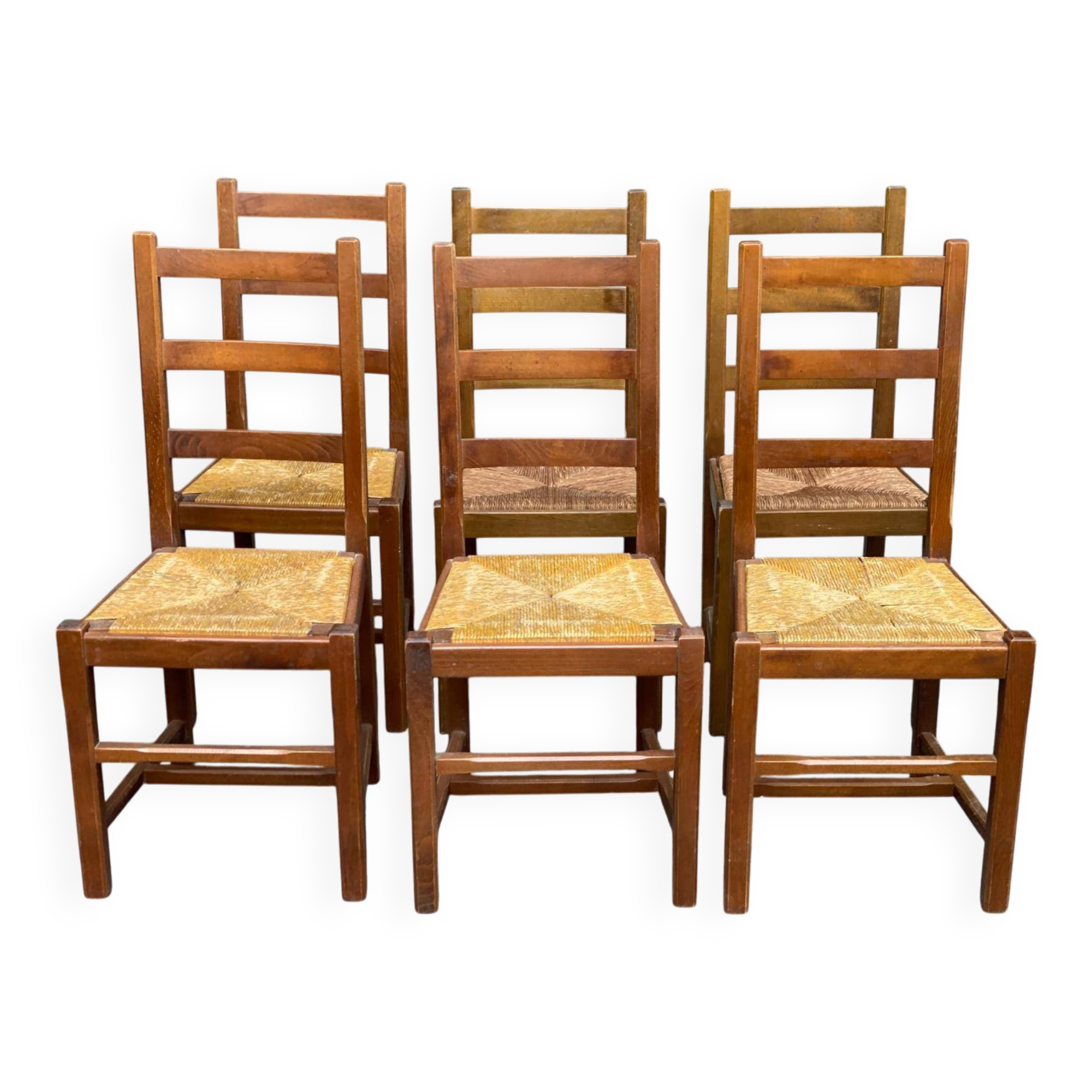 6 light solid wood chairs with high straw backs, farmhouse style.
