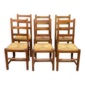 6 light solid wood chairs with high straw backs, farmhouse style.