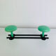 Wall-mounted coat rack with 2 green hooks from the 1950s.