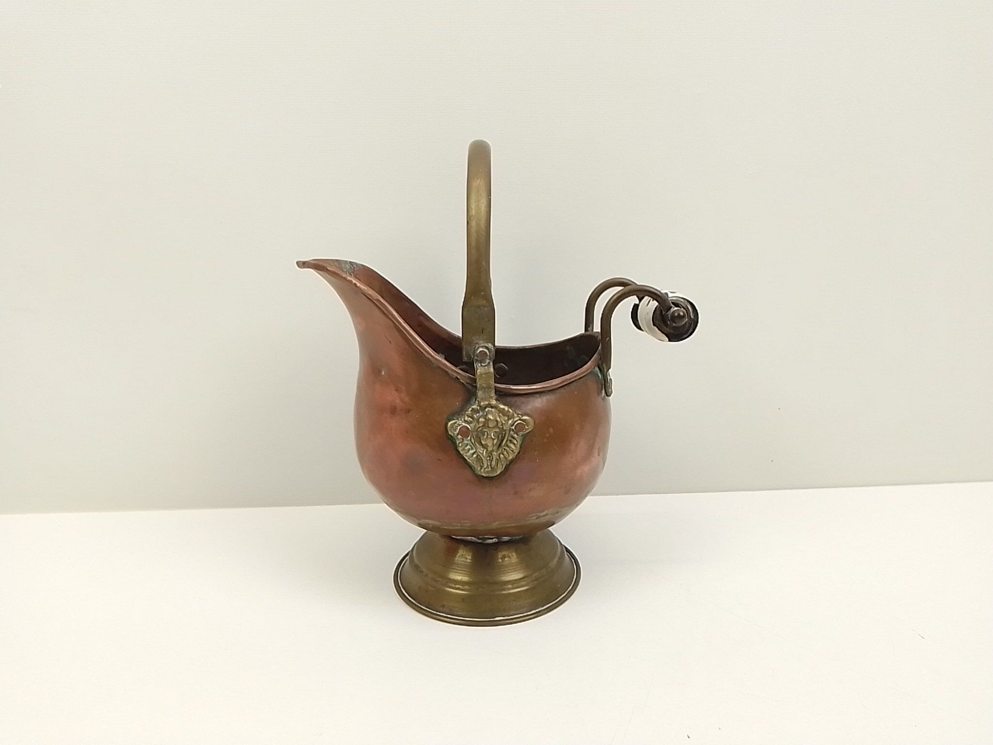 Copper pot cover and a pitcher-style brass handle