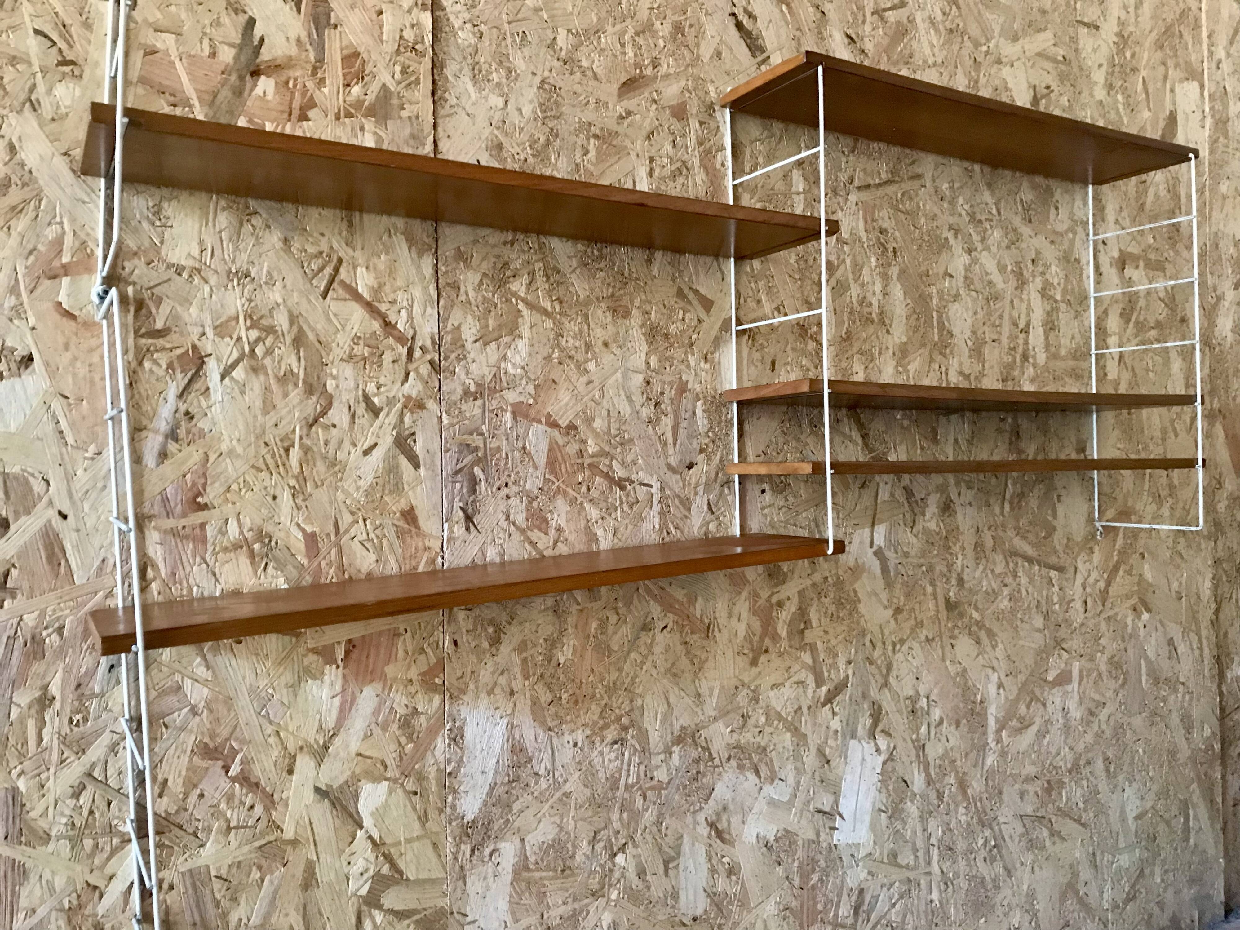 Vintage modular wall shelf with 4 supports and 5 levels.
