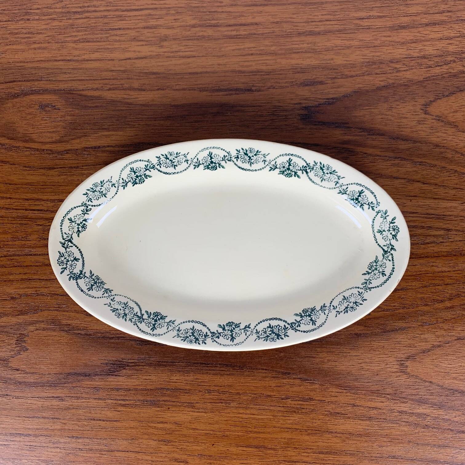 Small St Amand Ceranor dish, dark green flower pattern