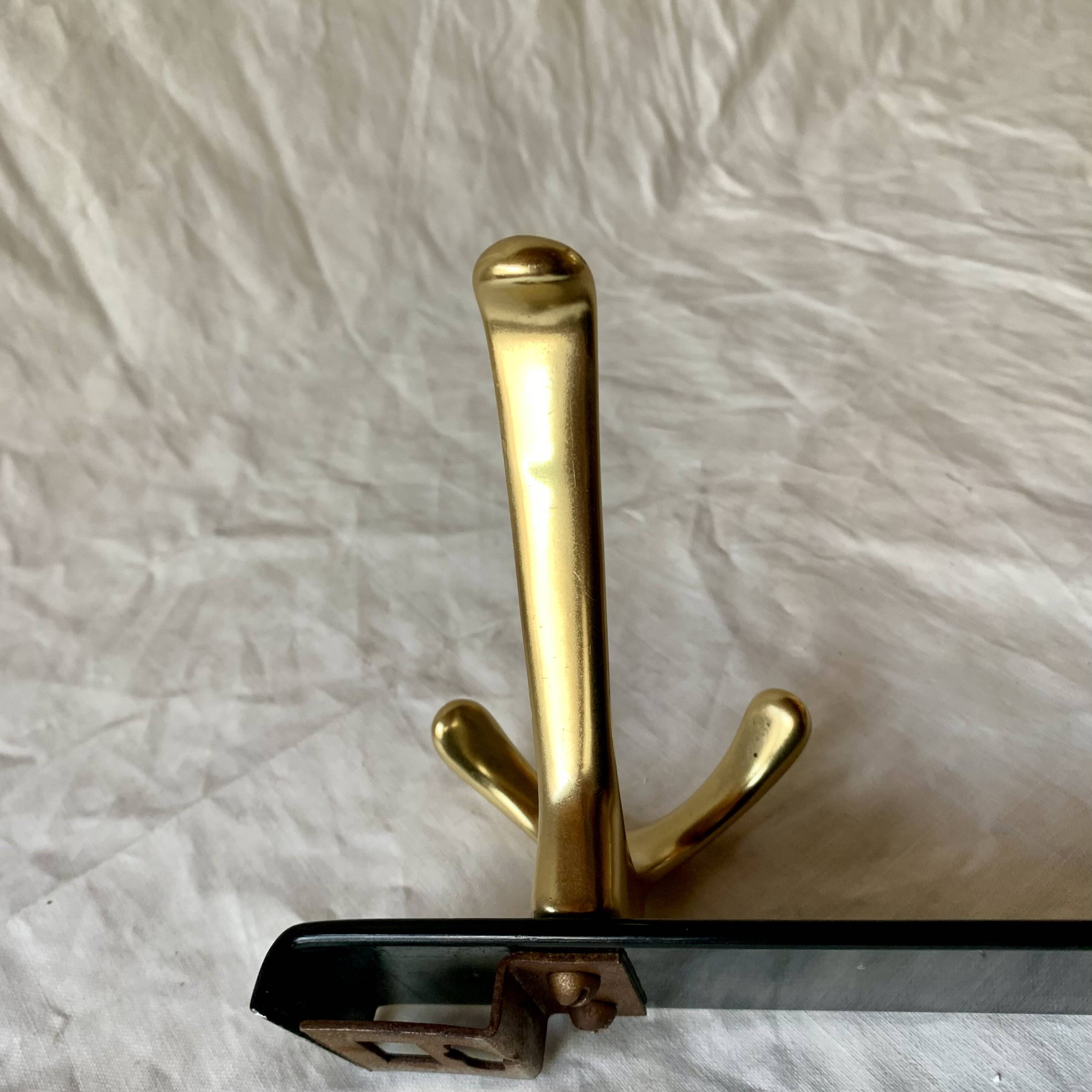 Vintage coat rack in lacquered metal with three golden aluminum hooks