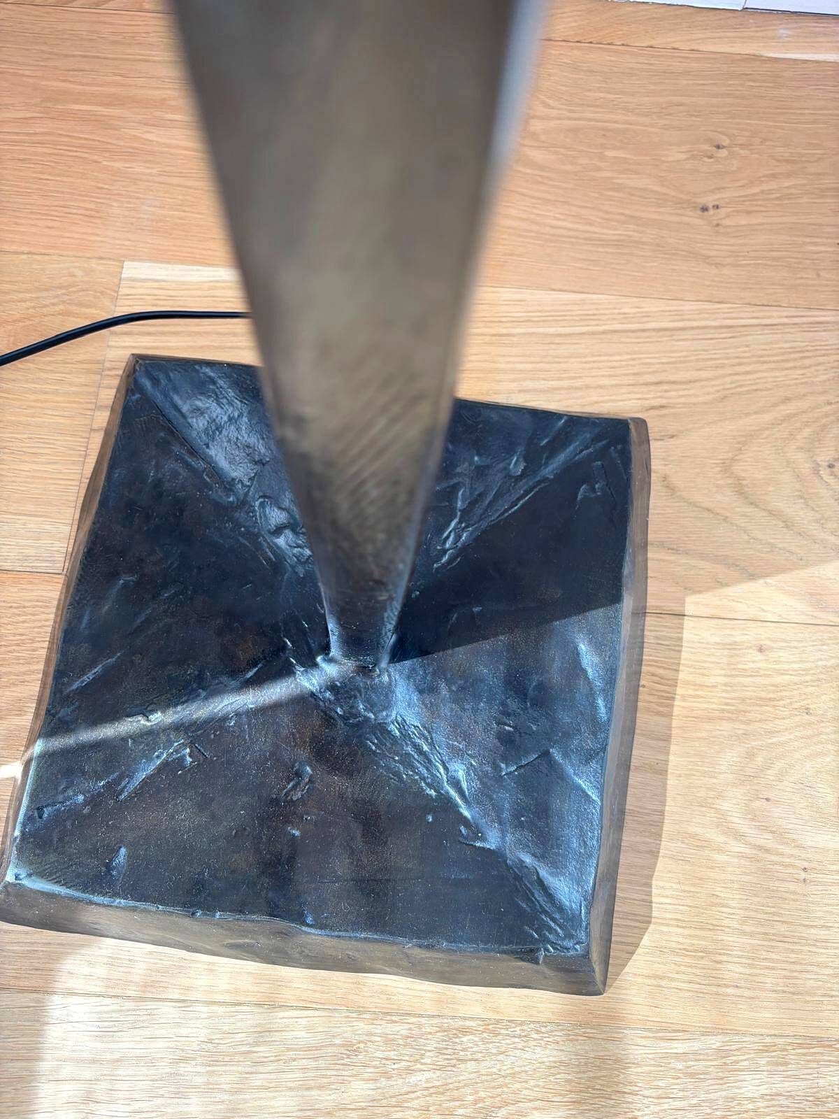 Pair of hammered black metal floor lamps with white shades.