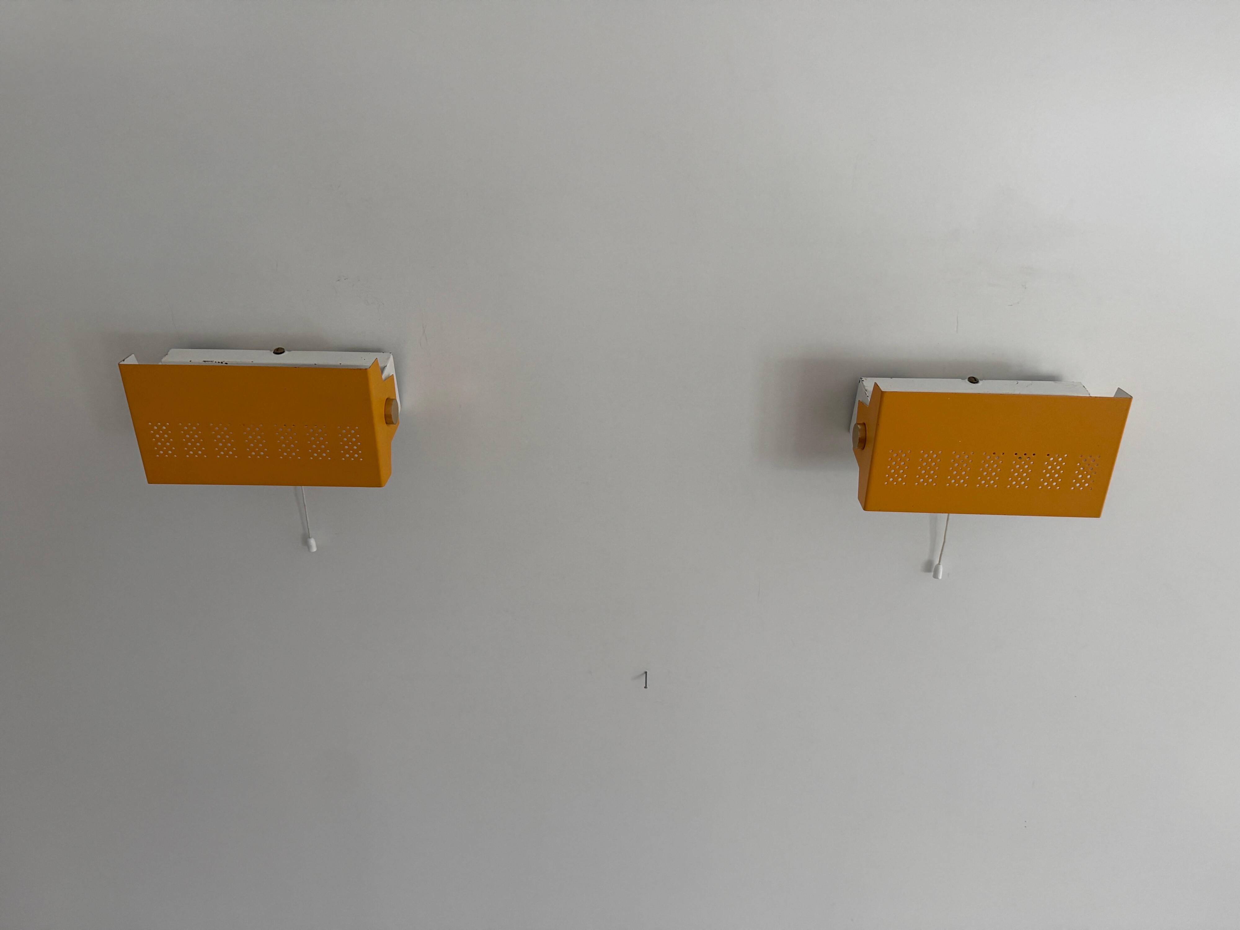Pair of yellow metal wall lights from the mid-century by N Leuchten, 1960s, Germany.