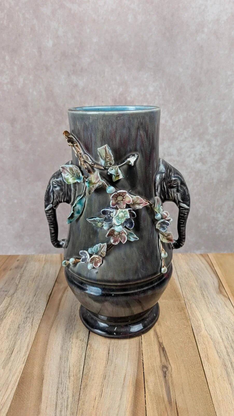 Antique vase in slipware with elephant and flower decoration.