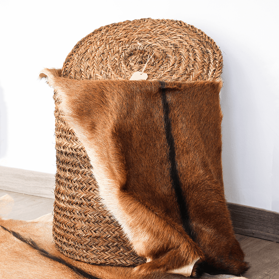 Hand-woven laundry basket in natural rush
