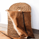 Hand-woven laundry basket in natural rush