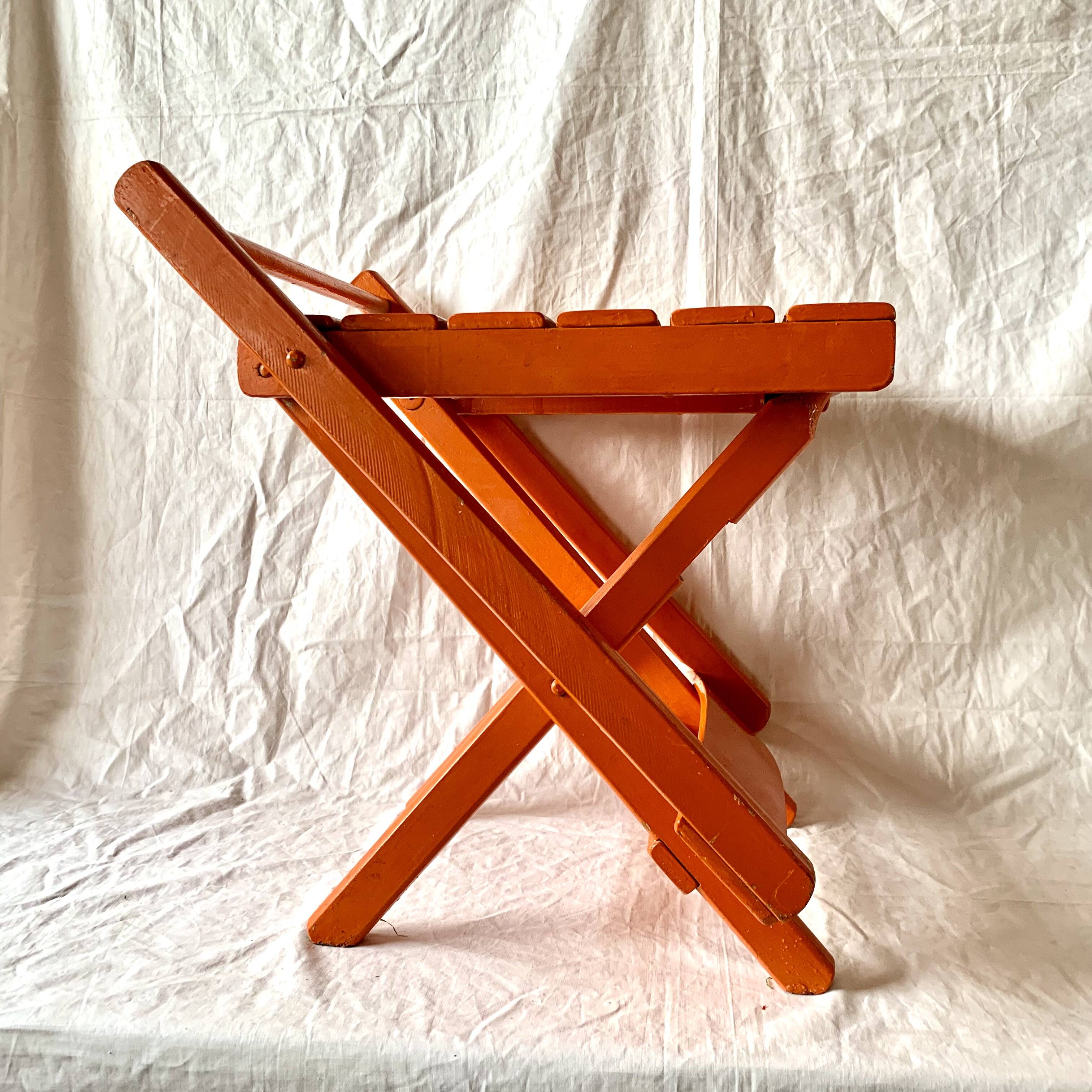 Vintage folding chair in orange painted wood