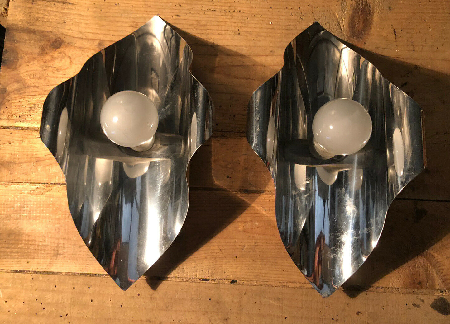 Pair space Age chrome metal wall appliques