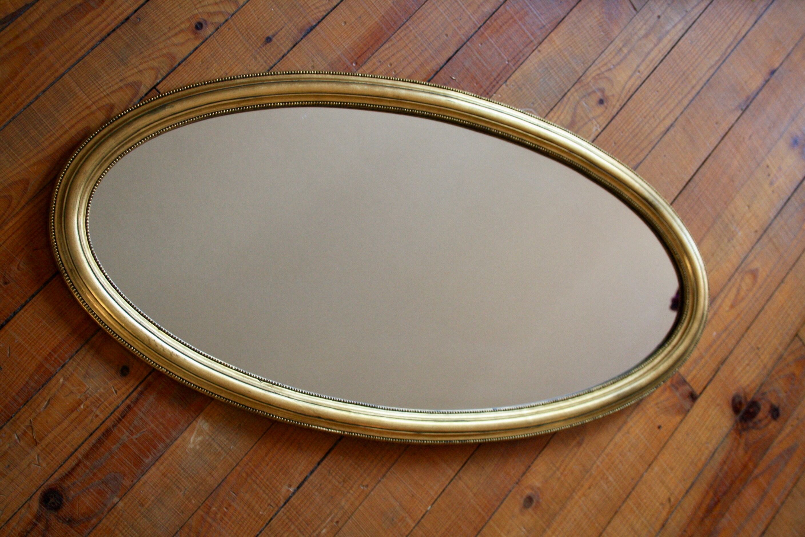 Miroir ovale en bois doré 80x42 cm