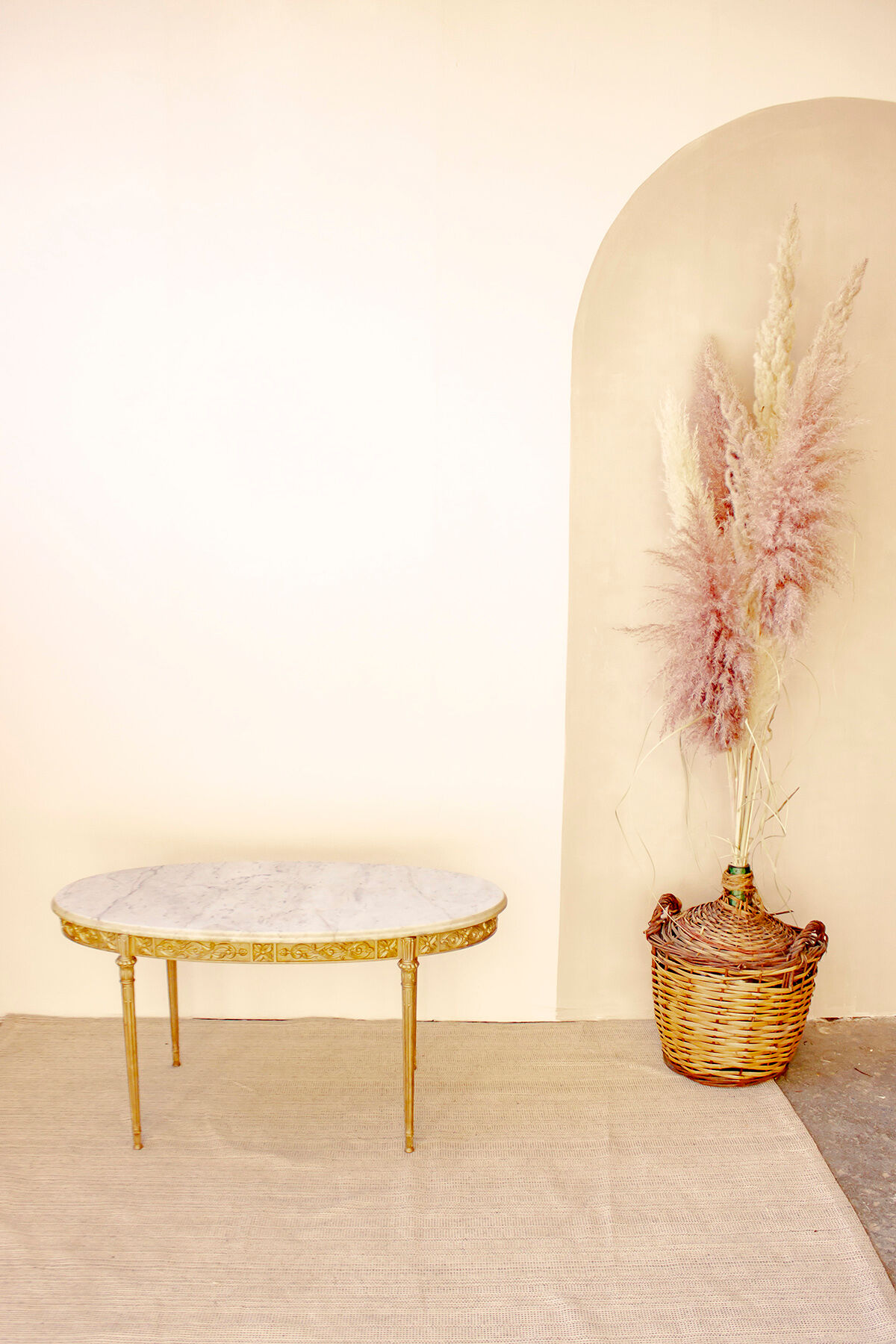 Oval coffee table in marble and brass