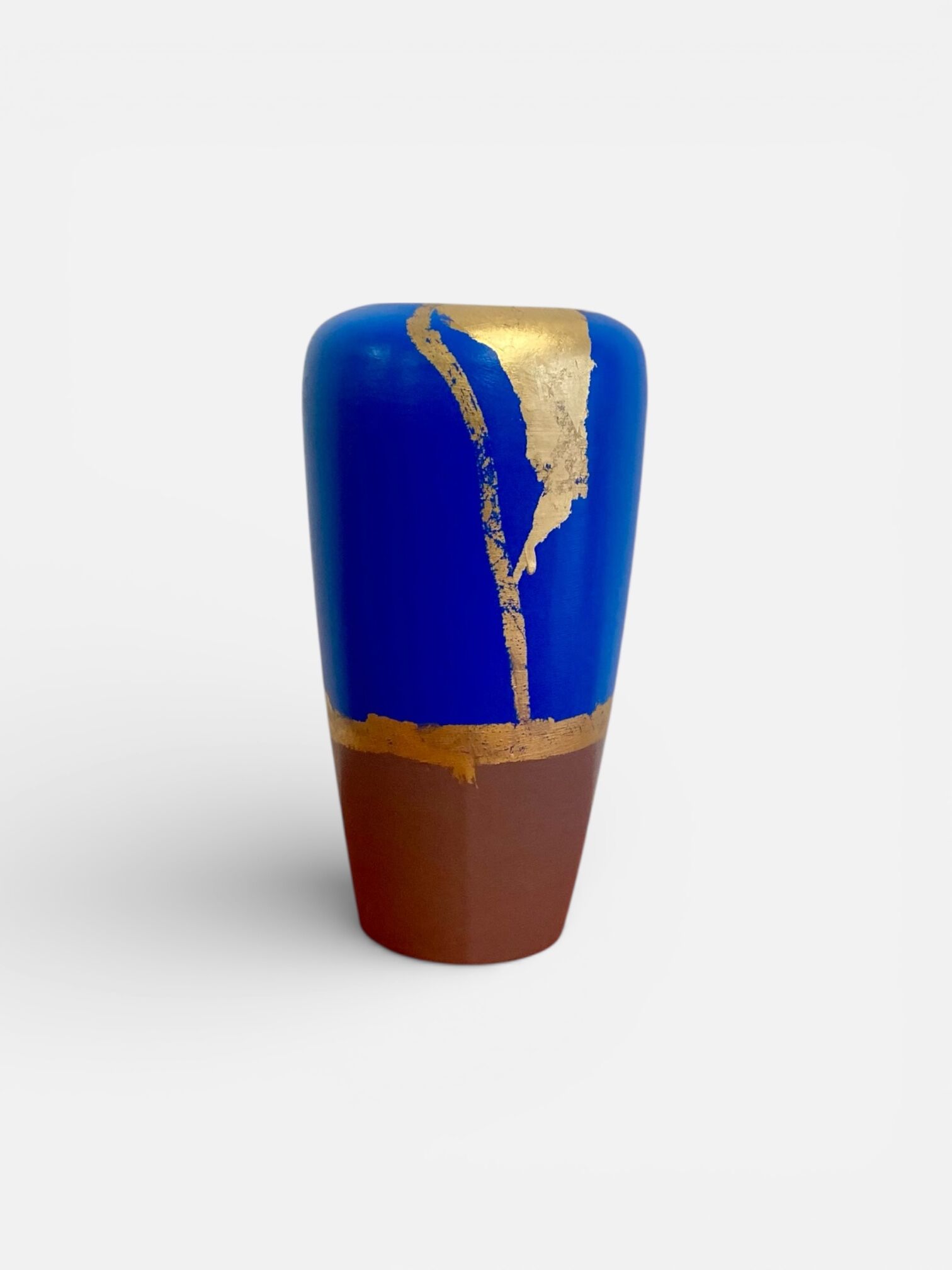 Electric blue and frosted brown decorative vase with gold leaf.