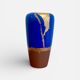 Electric blue and frosted brown decorative vase with gold leaf.