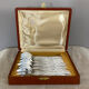 Art Deco oyster forks in punched silver metal, leatherette box