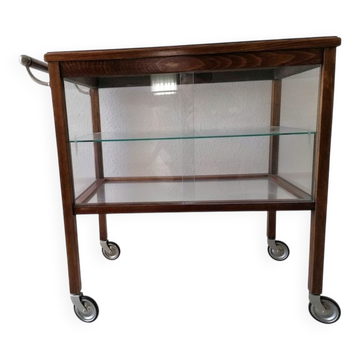 Art Deco brown wooden and glass bar cart, mobile display cabinet from the 1950s.