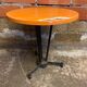 Vintage bistro table with black cast iron base and orange bakelite top, 1950s