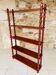 Vintage 5-tier turned wood shelf on legs.