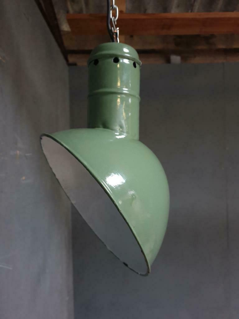 Old industrial enamel lamp in green