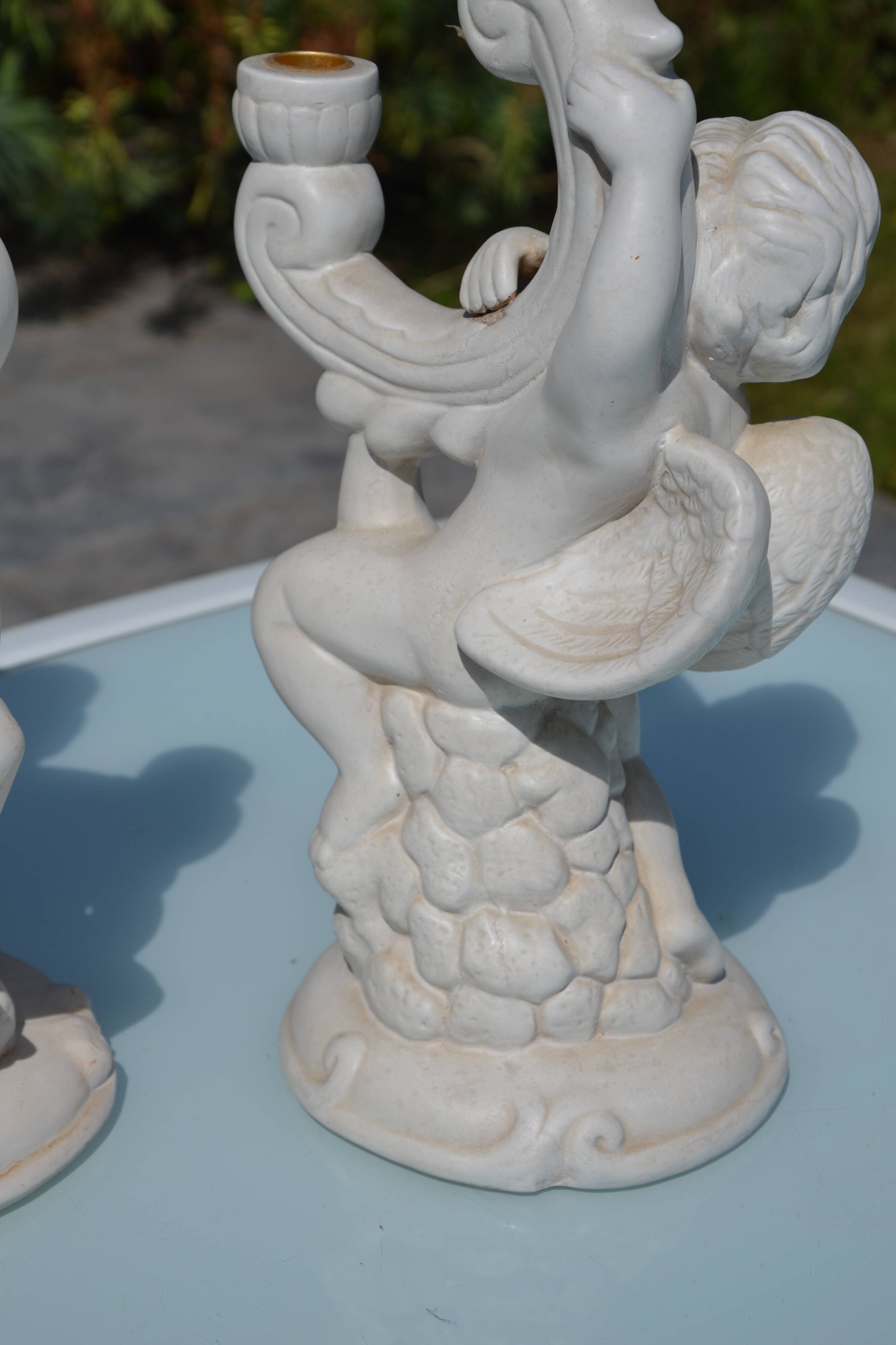 Pair of "cherub" candle holders in plaster