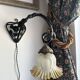 Art Nouveau wall light in wrought iron with vine decoration, early 20th century.