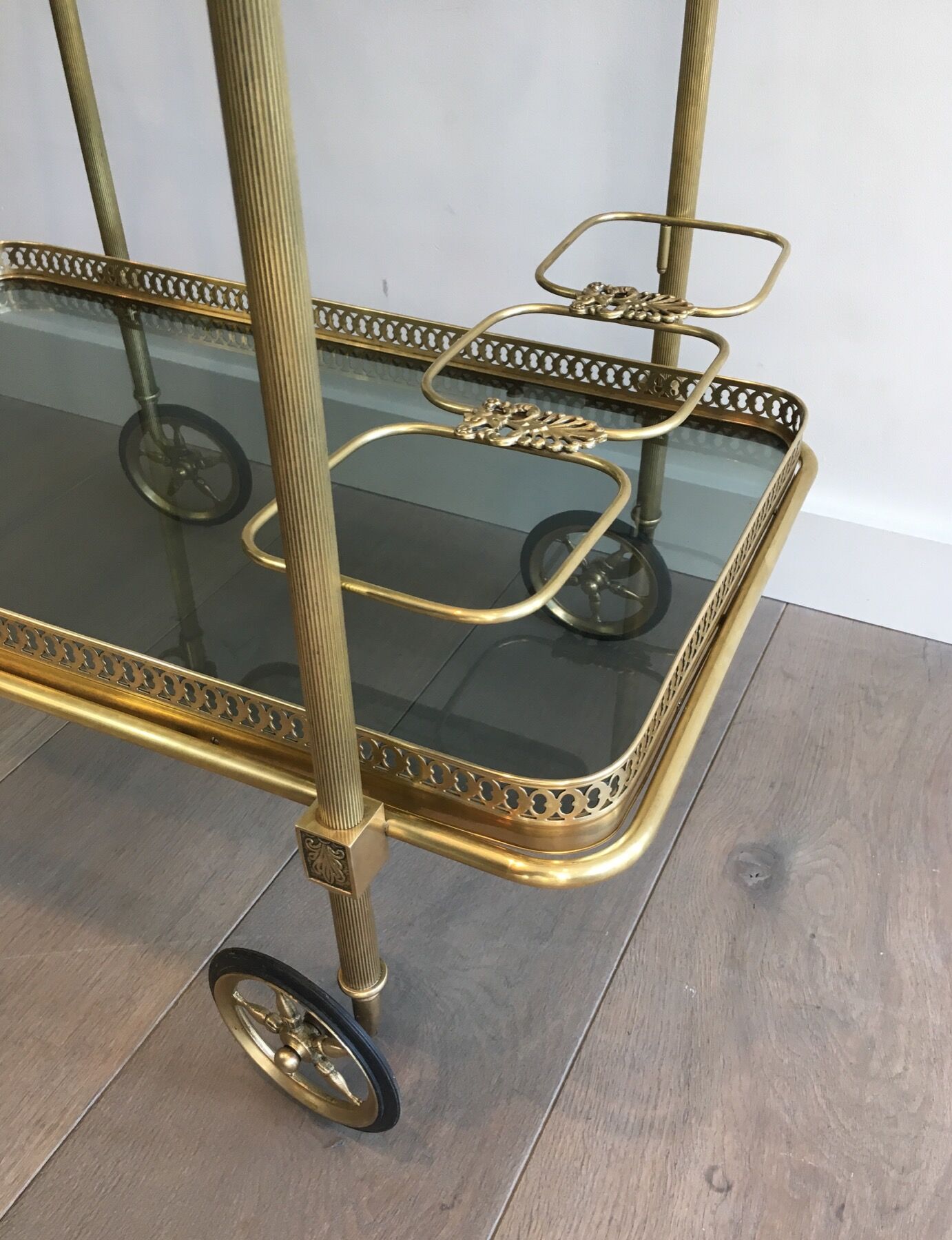Neoclassical style rolling table in brass with blue glass tops