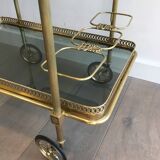 Neoclassical style rolling table in brass with blue glass tops