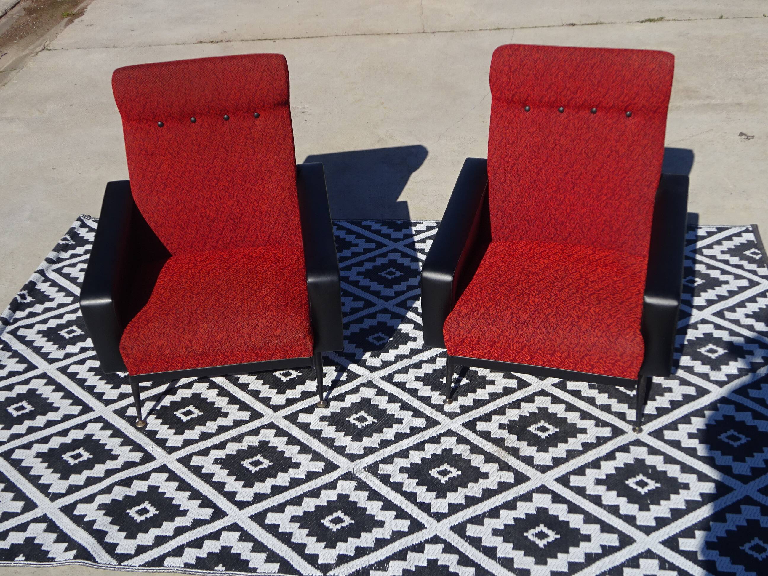Vintage armchairs in red and black faux leather, the pair.