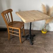 Bistro table with a central cast iron base in industrial style.