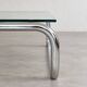 Coffee table in chrome with a glass top.