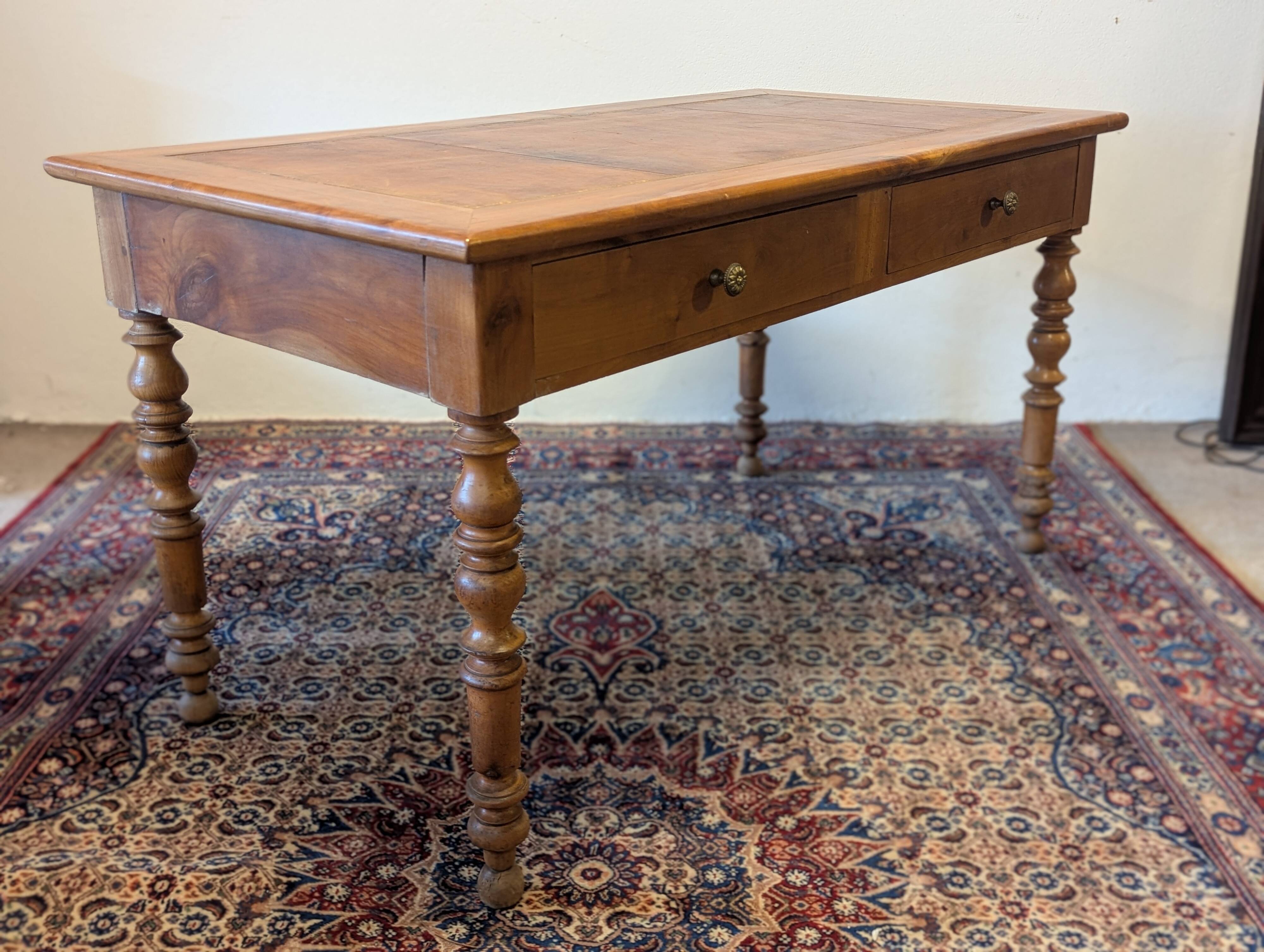 Cherry wood desk with a leather top.