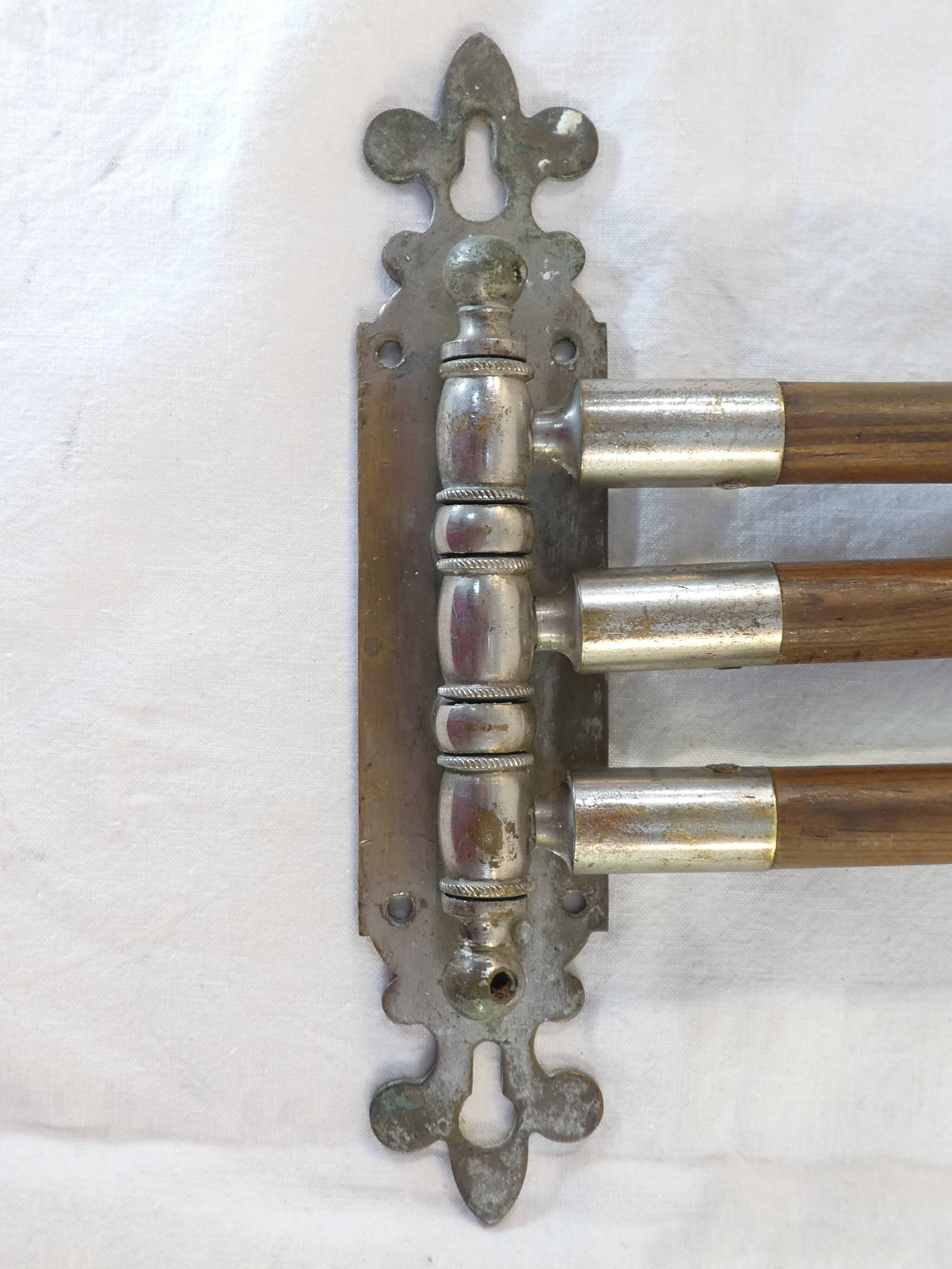 Antique towel rack has three arms