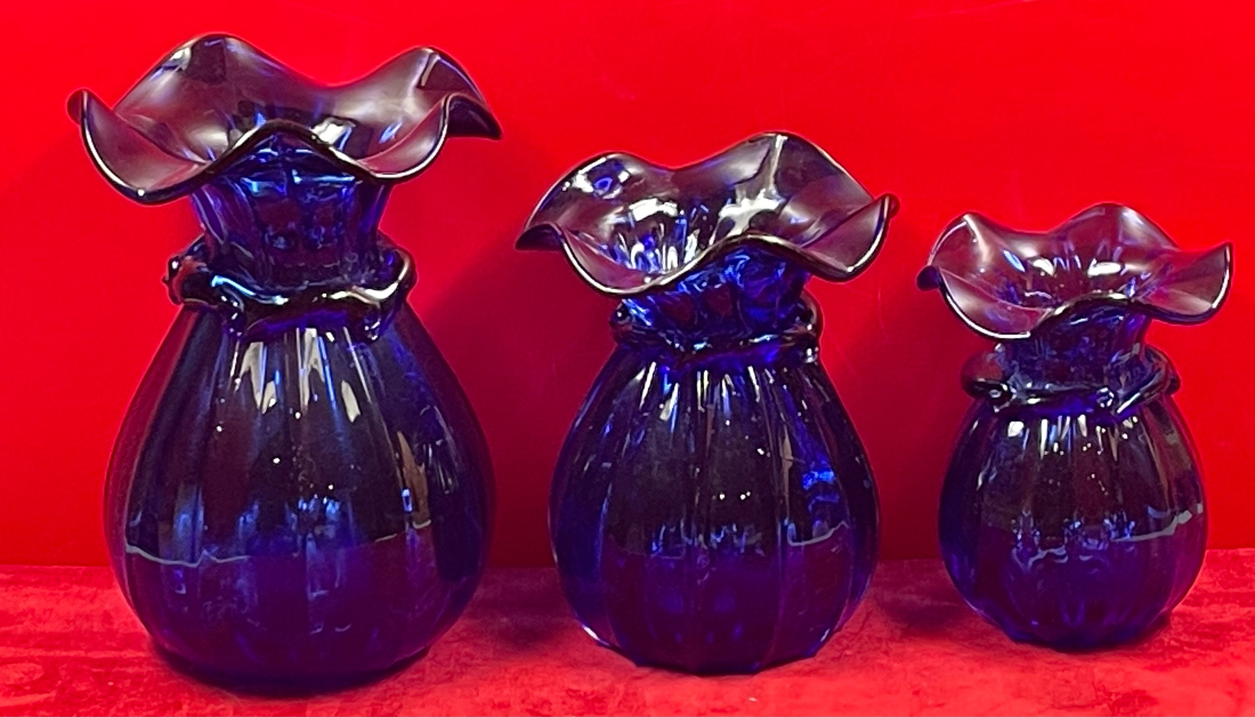 Series of 3 blue glass vases in the shape of a purse, 11, 13 and 17 cm