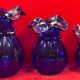 Series of 3 blue glass vases in the shape of a purse, 11, 13 and 17 cm