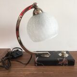 Art-deco lamp on marble with its original metal frame and the globe is cracked glass.