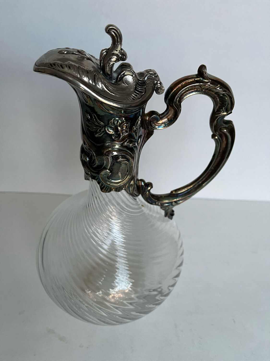 Glass decanter and silver metal frame