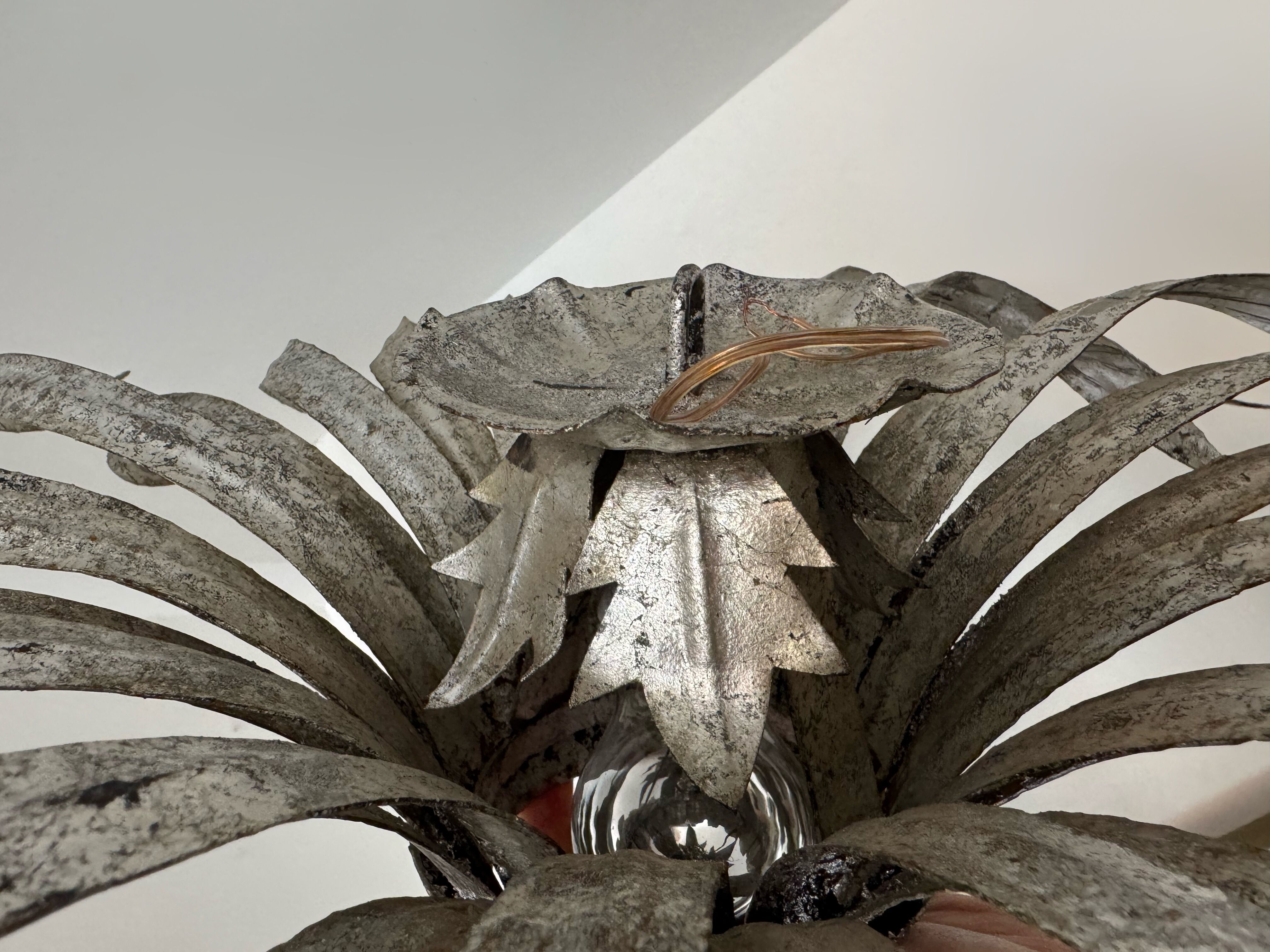 Silver wrought iron sunburst wall light from the 1960s.