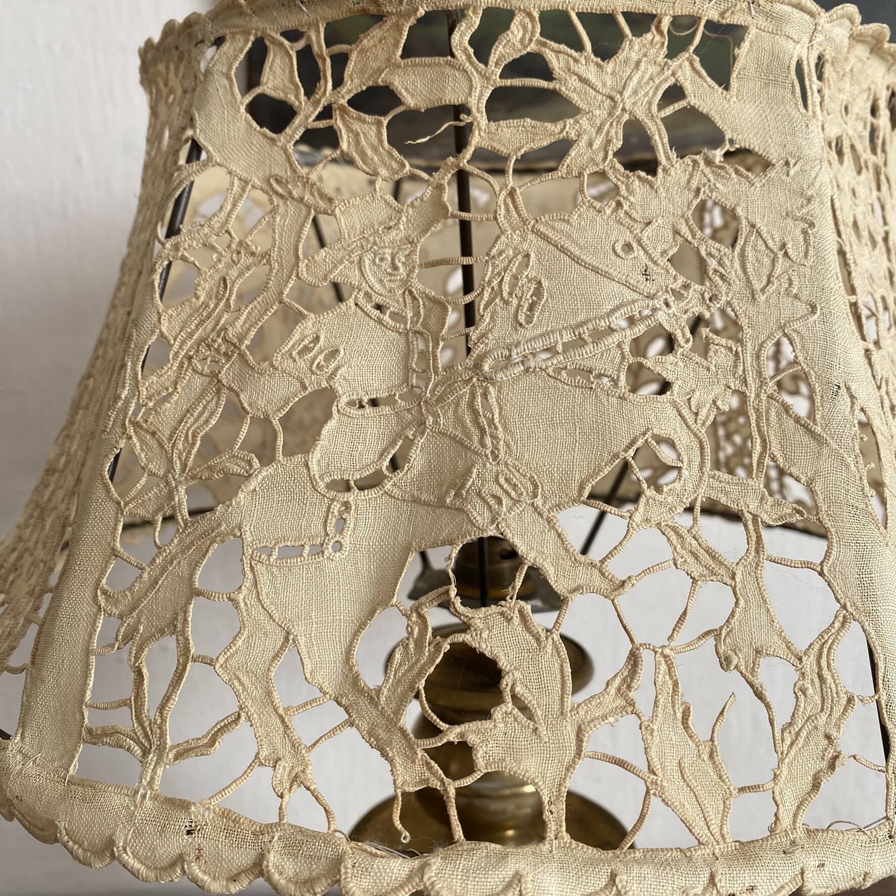 Antique brass lamp with embroidered openwork shade.