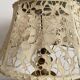Antique brass lamp with embroidered openwork shade.