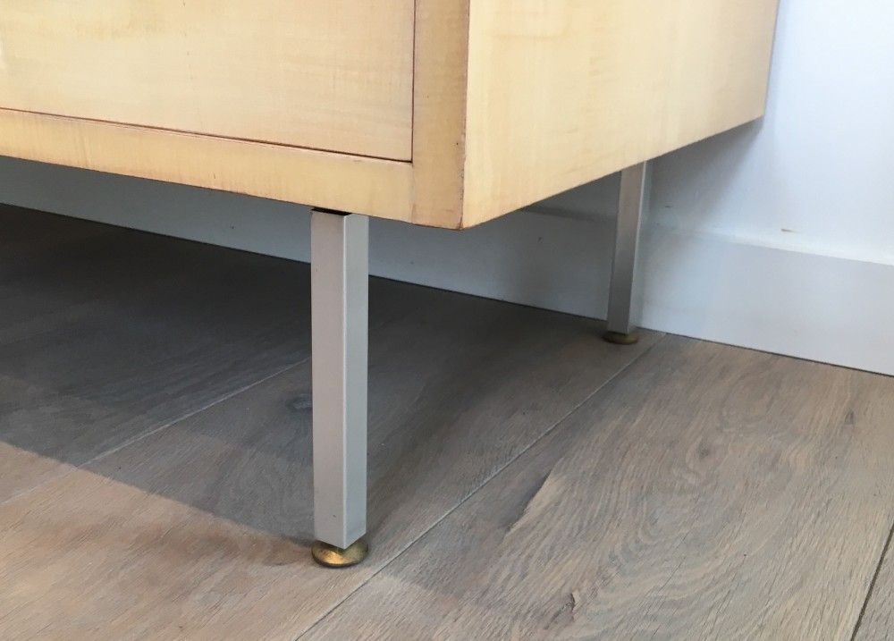 Eggshell lacquered chest of drawers with brushed steel legs. In the style of Knoll.