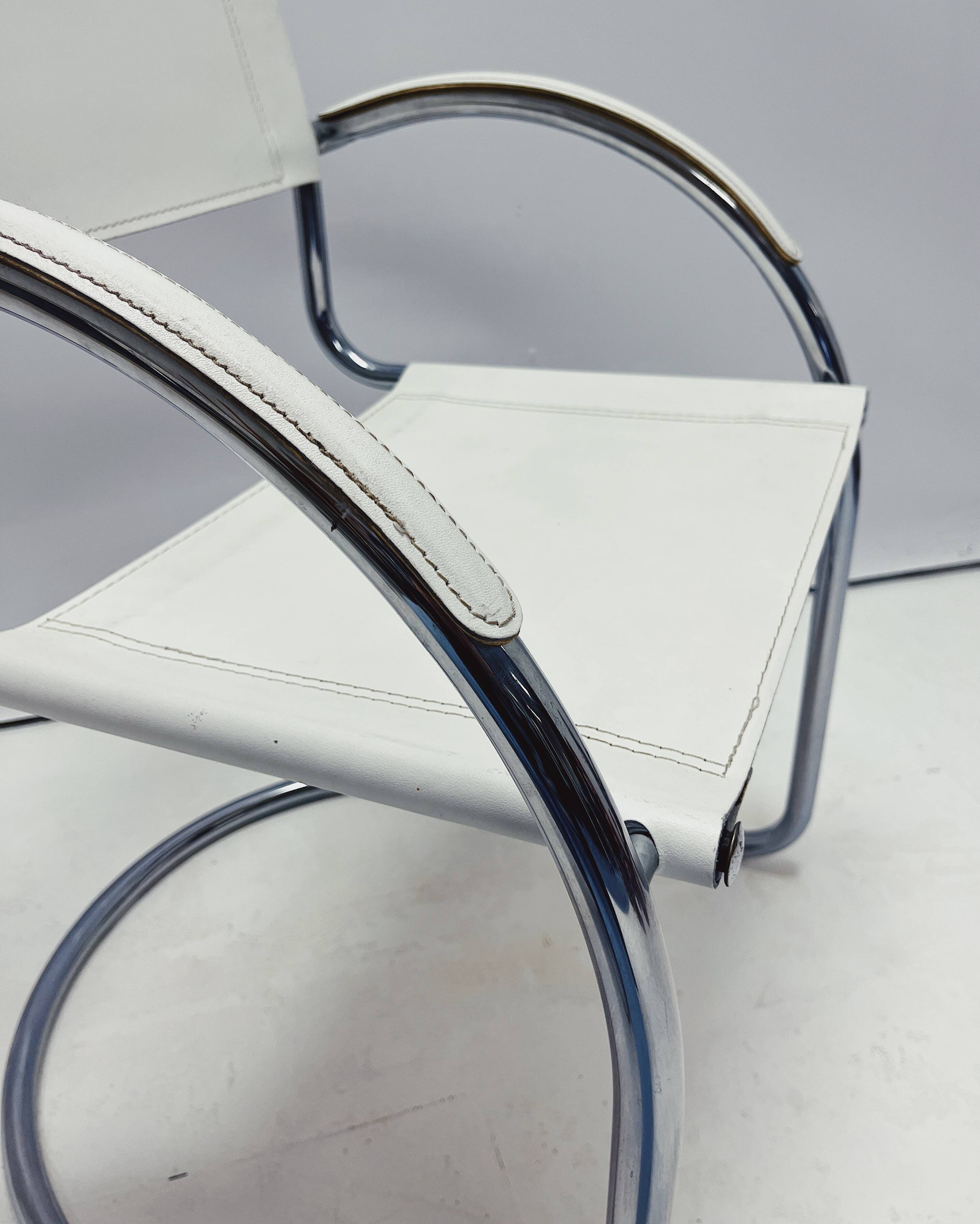 Vintage tubular frame chairs with white skai