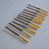 11 antique 19th-century table knives with ivory-colored monogram handles