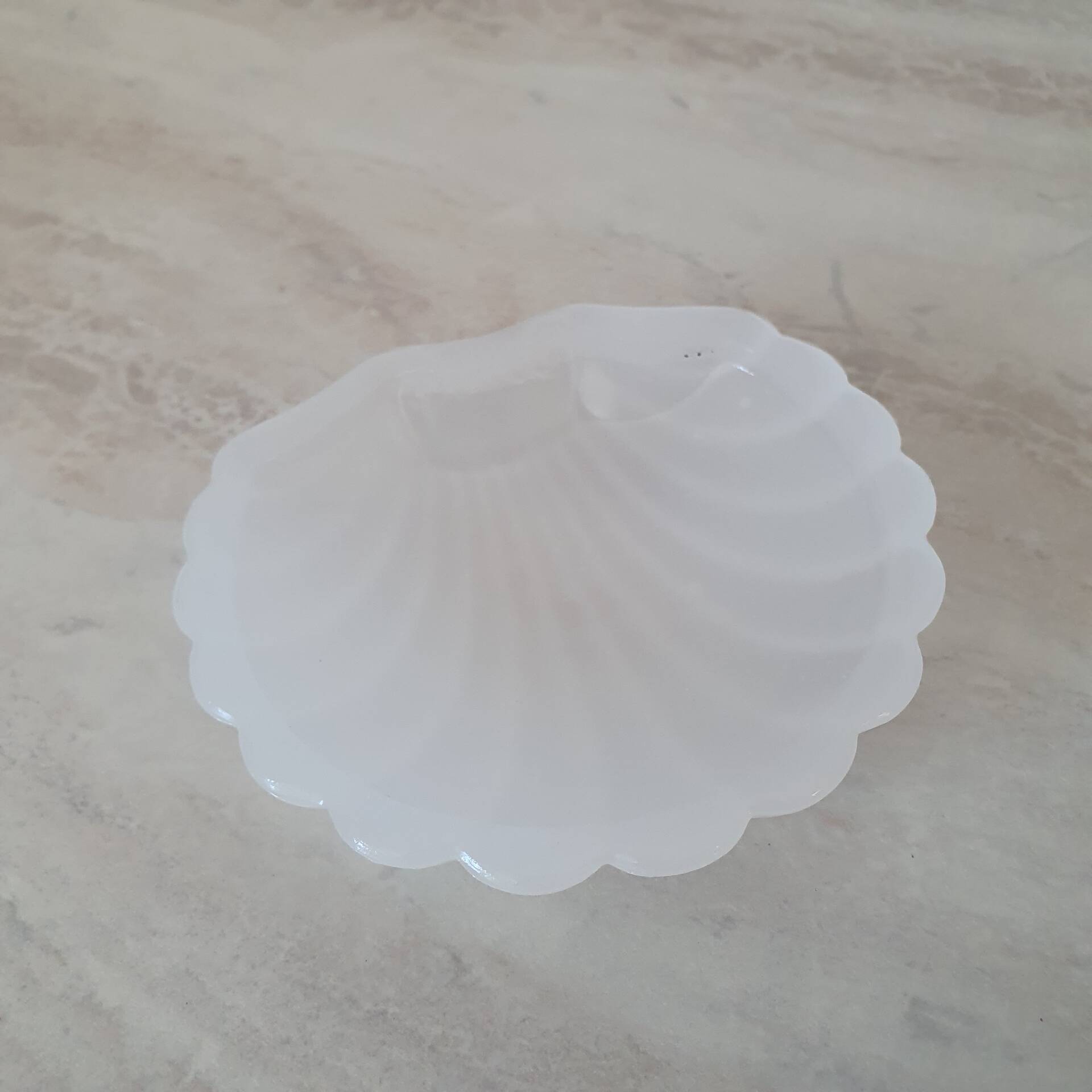 Scallop shell butter dish in stainless steel with its white glass saucer.