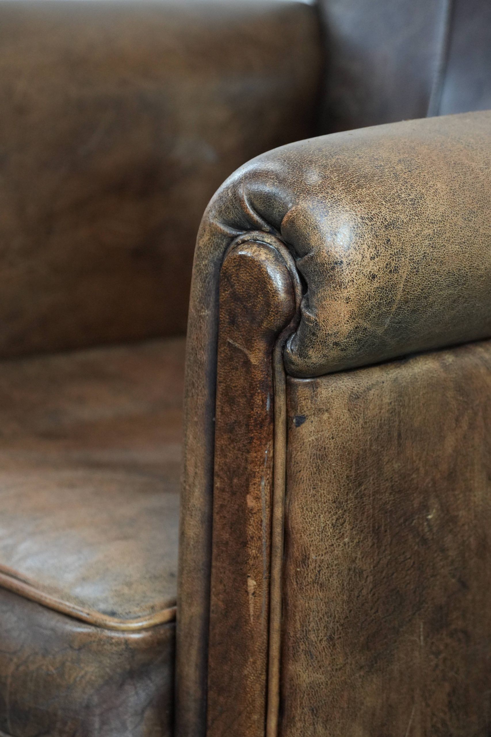 Vintage sheepskin armchair with warm colours and a characterful appearance