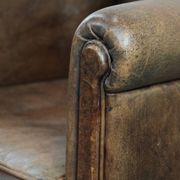 Vintage sheepskin armchair with warm colours and a characterful appearance