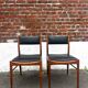 Set of 2 vintage Scandinavian chairs in wood and black faux leather.